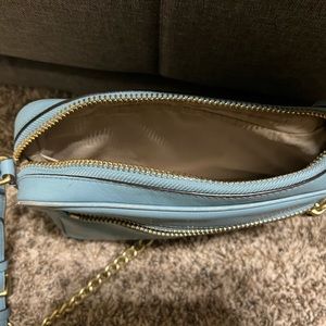 Coach light blue leather purse. It does contain a zipper.